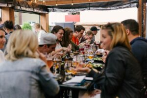 people eating a meal at a long table