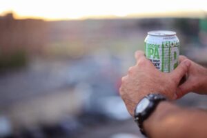 Goose island beer can in hand