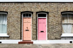 pink and salmon doors on brick apartment