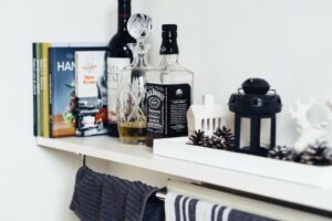 alcohol and books on top of cabinet
