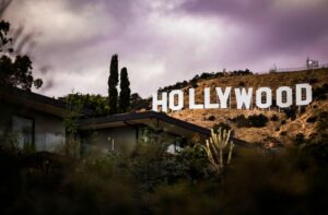 Hollywood sign with house in front and purple sky