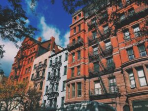 low angle view of nyc apartment building with blue skies