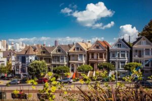 houses on a hill with blue skies above