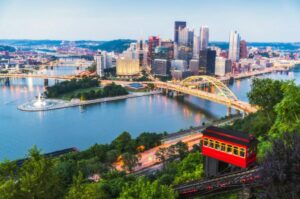 Aerial shot of Pittsburgh skyline and bridges at dusk