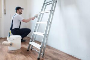 Professional painter worker is painting a wall