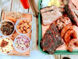 above shot of bbq plates with sides and meats