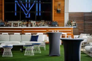 large outdoor bar with turf and patio furniture