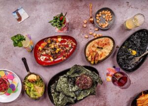 purple table with lots of different food dishes on it