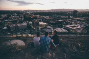 young people sitting on rock overlooking phoenix area