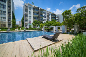 swimming pool at apartment complex with lounge chairs