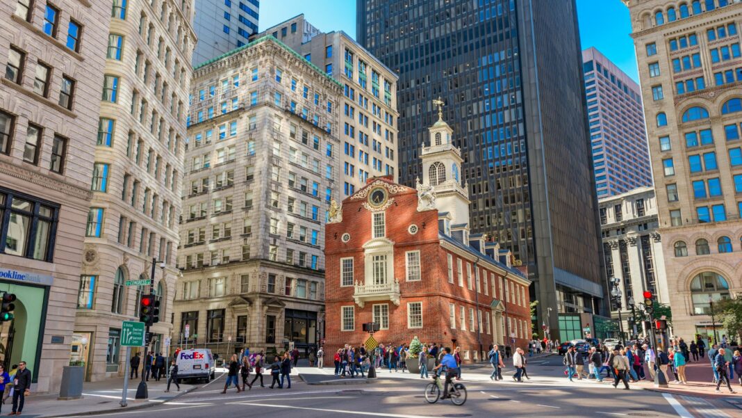 Pedestrians cross at the Old State House in Boston.