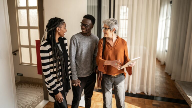Real estate agent showing apartment to young couple