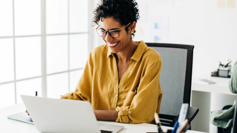 Creative business woman enjoys working on her project in an office.