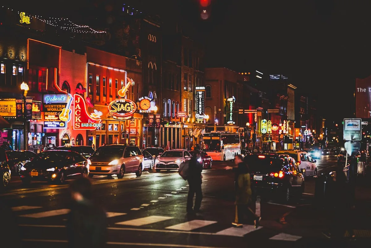 A photo of Nashville lit up a night, showing the vibrancy and energy that draws people to the city and ultimately leaves them asking if Nashville is affordable for renters.