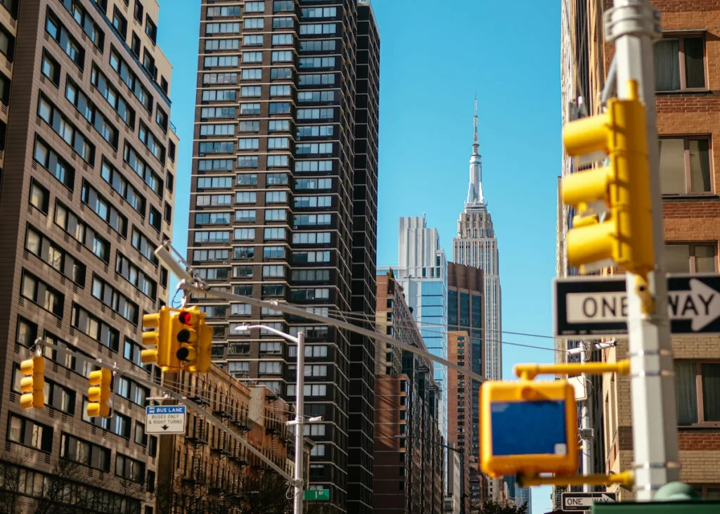 Street-level view of New York City with the Empire State Building, representing the dense neighborhoods renters compare for cheaper housing