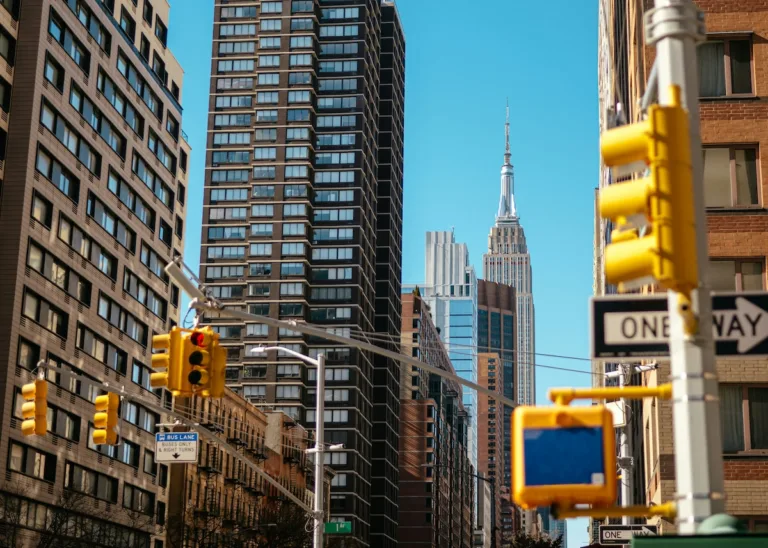Street-level view of New York City with the Empire State Building, representing the dense neighborhoods renters compare for cheaper housing