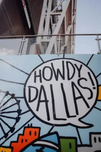 urban art saying "howdy Dallas!" for an article about the cheapest neighborhoods in Dallas
